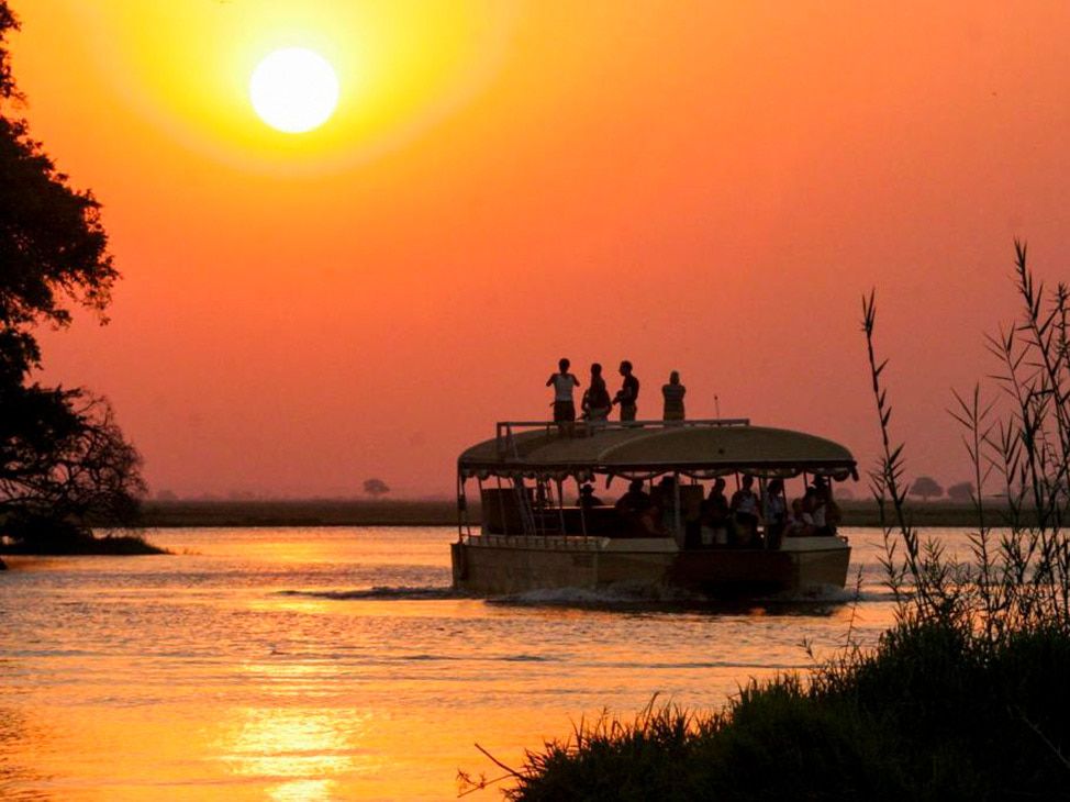 Wildlife cruise boat with sunset in Botswana