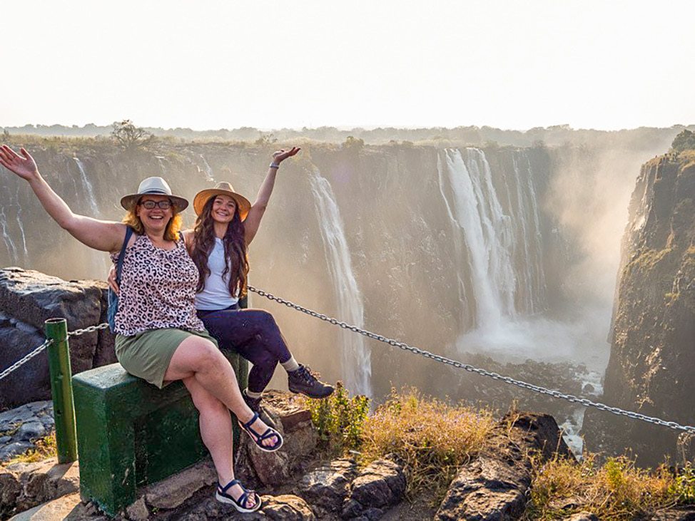 2 women in front of Victoria Falls