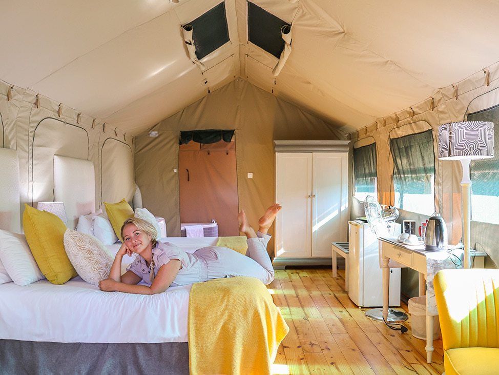 Woman on bed in luxury tent Namibia