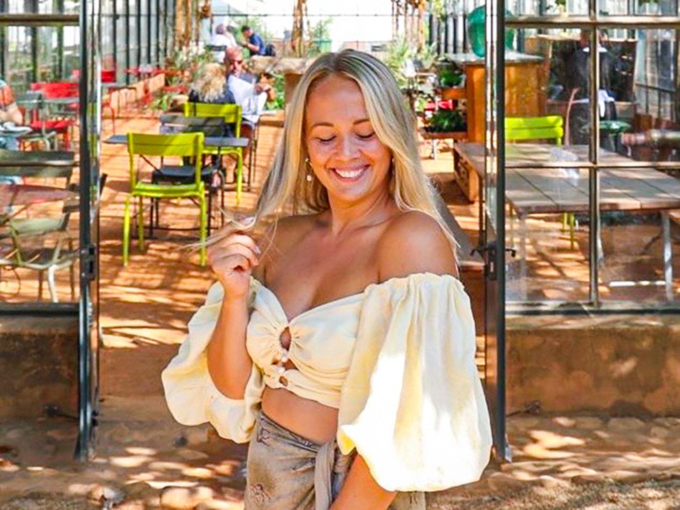 Woman in front of greenhouse Botswana