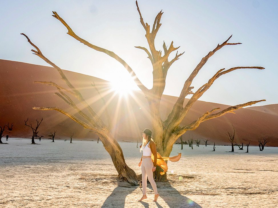 Woman in front of dead trees at Deadvlei Namibia