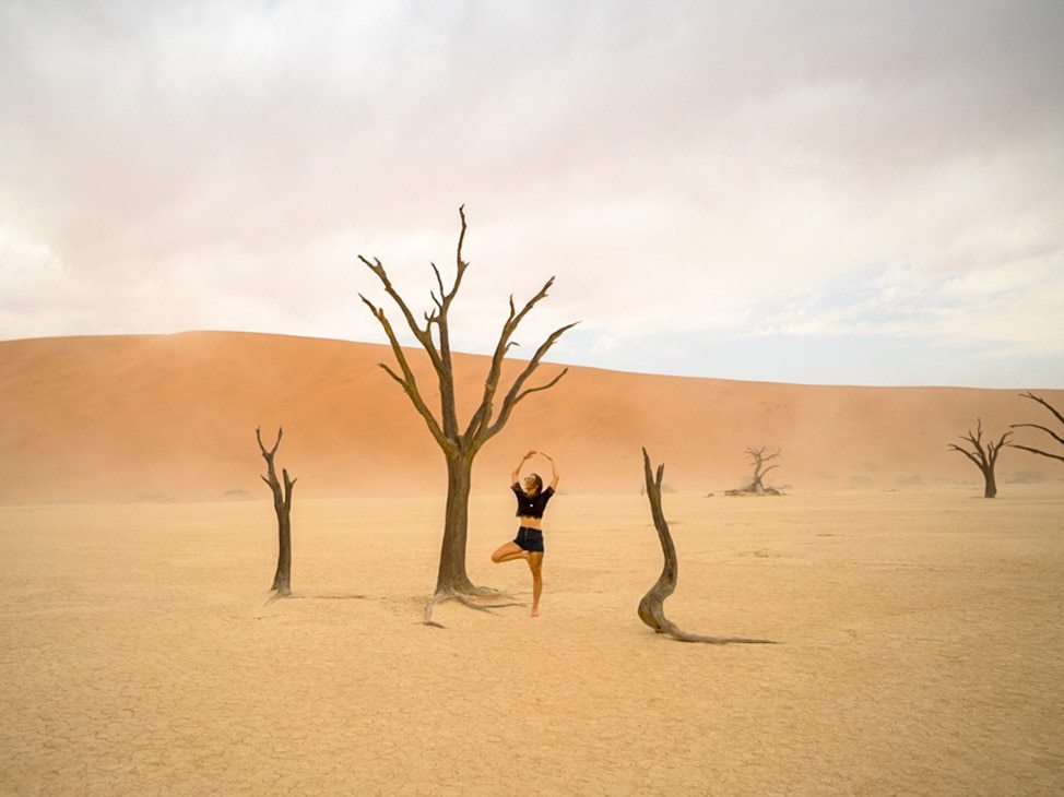 Woman doing yoga pose in Deadvlei