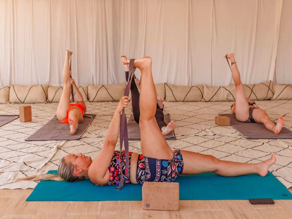 Wander women doing yoga on retreat