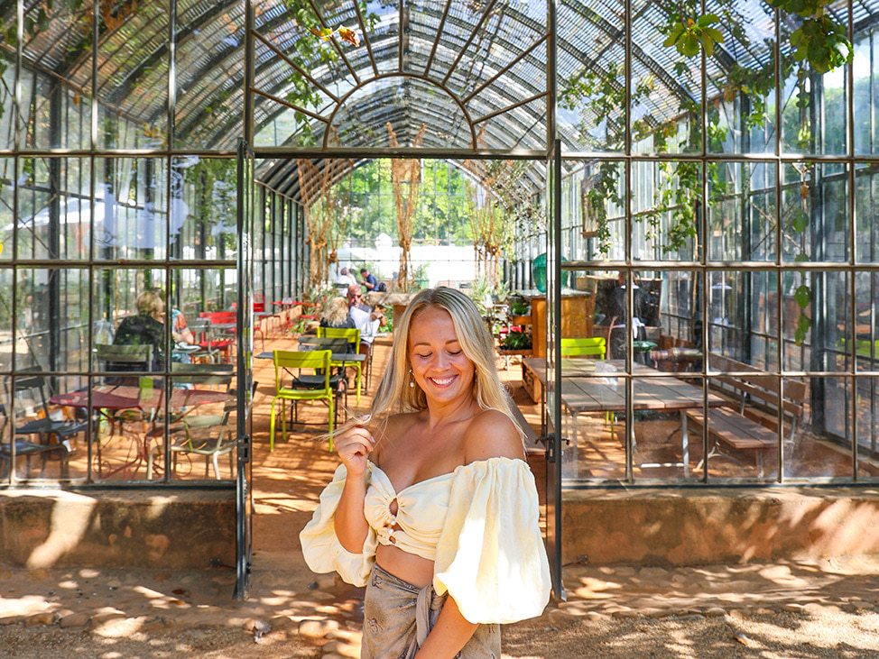 Woman in foreground in front of greenhouse Namibia Retreat