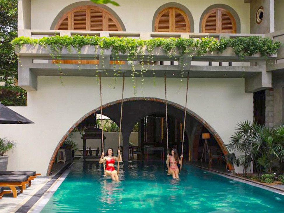 Women on swings in the pool in Sri Lanka